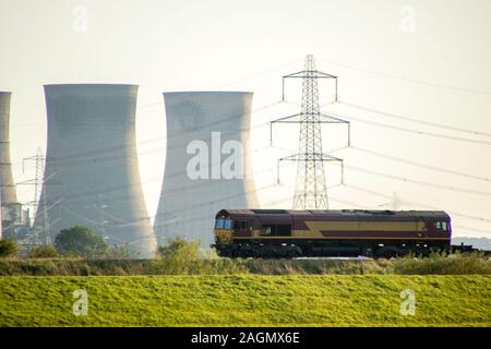 A freight train travels across the British countryside taking goods from A to B. Stock Photo