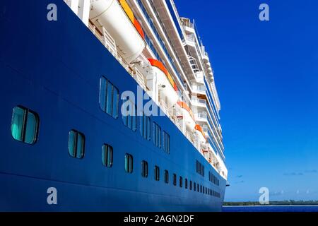 A view of a large cruise ship docked along the waterfront of Bahamas. Stock Photo