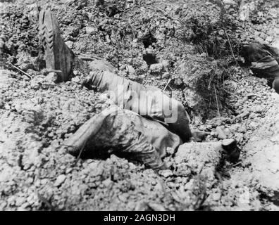 The feet and legs of deceased soldier protrude from the ground in a World War II German soldier's snapshot, ca. 1940. Stock Photo