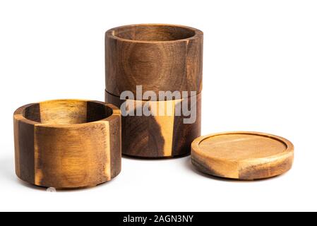 Three separate levels of stacking bamboo wood condiments vessel with lid cover on a plain white background. Stock Photo