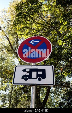 Two traffic information signs on a metal post, trees in the background Stock Photo