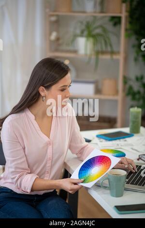 Beautiful nice young woman working from home Stock Photo