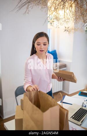 Nice pretty woman looking into the bag Stock Photo