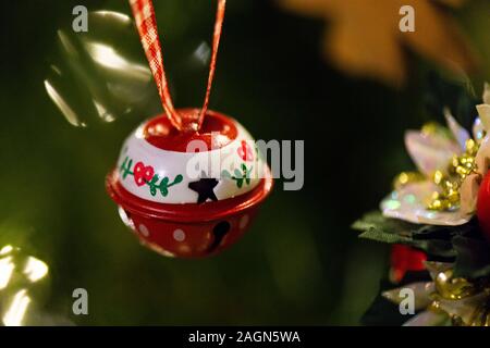 A bell hanging Christmas decoration hanging in a Christmas tree Stock Photo