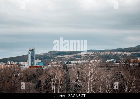 Banska Bystrica, Slovakia - March 11, 2019: clouds over town in a valley in cloudy day. Stock Photo