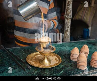 Preparing and pouring  Indian style Hot Tandoori Tea/Chai . Selective Focus is Stock Photo