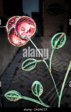Old cast iron decorative rose on an old iron gate. Stock Photo