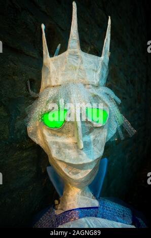 A spooky king figure made from plastic with glowing green eyes Stock Photo