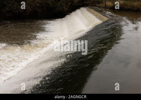 Fast flowing river irwell plunging over weir in burrs country park bury lancashire uk Stock Photo