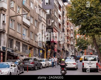 Istanbul , Turkey ; October 2019 : Long-shot of old apartments streets car people traffic normal day in asian country Stock Photo