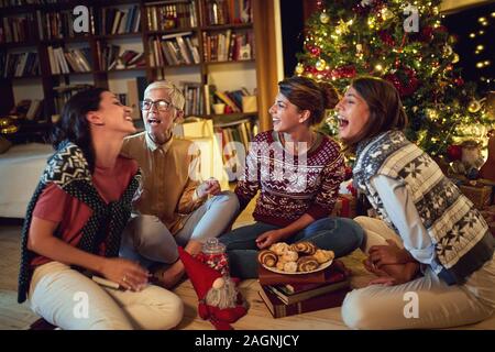 cheerful family together for Christmas.Smiling mother and happy daughter enjoying in traditional decorated Christmas Stock Photo