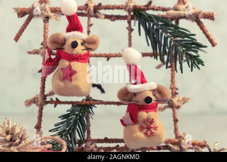 Two Little toy Christmas mice and decorations from natural materials on table. Christmas composition with symbol 2020 of Chinese horoscope Stock Photo