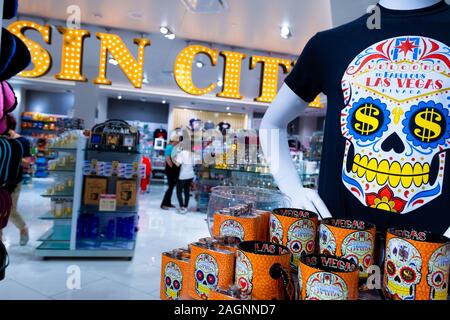 Interior shot of a large Sin City sign and skull t-shirt and mugs on display in a souvenir shop inside the Forum Shops, Las Vegas, Nevada, USA Stock Photo