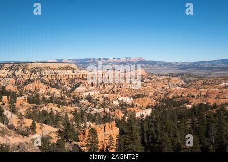 Bryce Canyon National Park, a sprawling reserve in southern Utah, is known for crimson-colored hoodoos, which are spire-shaped rock formations. Stock Photo