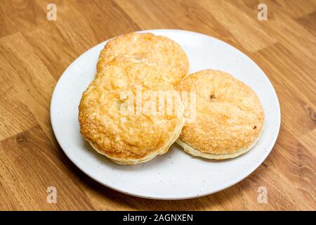 Puff pastry mince pies on a white plate Stock Photo
