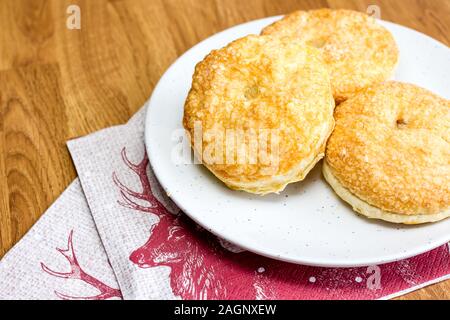 Puff pastry mince pies on a white plate Stock Photo