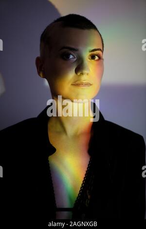 Close-up portrait of young bald woman in creative light. Stock Photo