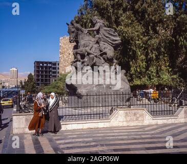 Pleasant street scenes in old Damascus as ladies go about their daily business passing the memorial to the Arab Warrior Commander Saladin Stock Photo