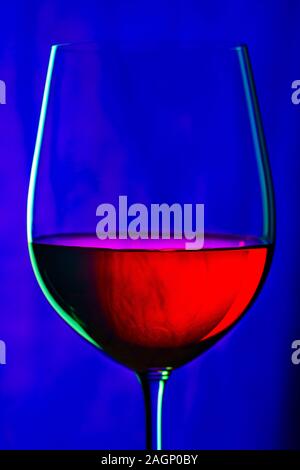 Glass of red wine on dark blue background Stock Photo