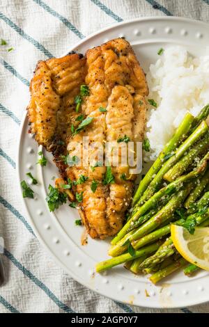 Homemade Sauteed Whitefish Dinner with Asparagus and Rice Stock Photo