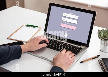 Password login on computer screen, Unlock laptop, cyber lock internet security concept. Man working on an office desk Stock Photo
