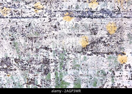 Background of old weathered concrete painted in white green and yellow. Stock Photo