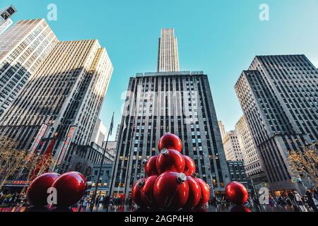 New York, NY, USA - November 30, 2019. Streets of Manhattan, Sixth Avenue with huge red Christmas decoration balls, near Radio City Music Hall, NY