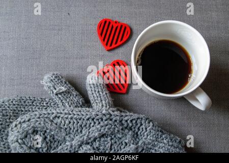 Coffee, red hearts and warm gloves on a cold winter day Stock Photo
