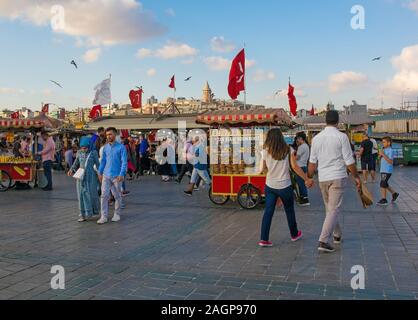 Istanbul, Turkey - September 9th 2019. Locals and tourists walk past the many food stalls along the waterfront area of Eminonu in the Fatih district o Stock Photo