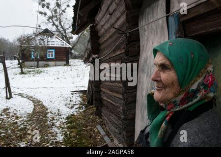 Hanna Zavorotnya at her farm in Kupovate inside the Chernobyl Exclusion Zone. She is a self settler (Samosely), one of the babushkas who refused to leave the Zone. In the summer after the evacuation (following the Chernobyl disaster 1986) she and her family turned back to their farm. Zavorotnya and the other women who remained of the village lived through Stalin’s Holodomor – the genocide-by-famine of the 1930s that wiped out millions of Ukrainians – and then the Nazis in the 1940s. After the Chernobyl accident many were simply unwilling to flee an enemy that was invisible. Kupovate, Ukraine Stock Photo