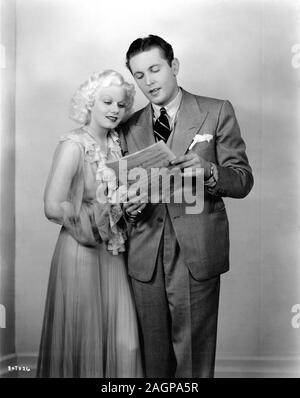 JEAN HARLOW and ALLAN JONES on set candid during filming of RECKLESS 1935 director VICTOR FLEMING producer DAVID O. SELZNICK Metro Goldwyn Mayer Stock Photo