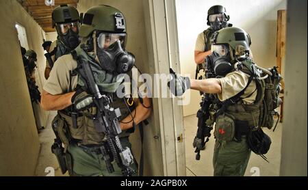 FBI SWAT - Special Weapons And Tactics team practices an interior assault. Stock Photo