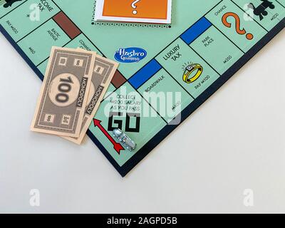 Orlando, FL/USA-12/20/19:  The race car  on the Passing Go square for the game Monopoly by Hasbro on a white background.  Concept business, banking, a Stock Photo