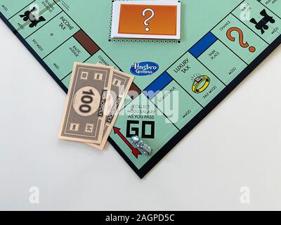 Orlando, FL/USA-12/20/19:  The race car  on the Passing Go square for the game Monopoly by Hasbro on a white background.  Concept business, banking, a Stock Photo