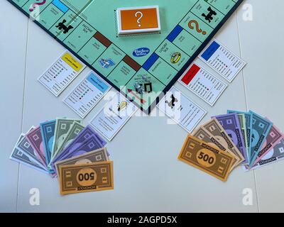 Orlando, FL/USA-12/20/19:  Pieces for the game Monopoly by Hasbro on a white background.  Concept business, banking, and property. Stock Photo