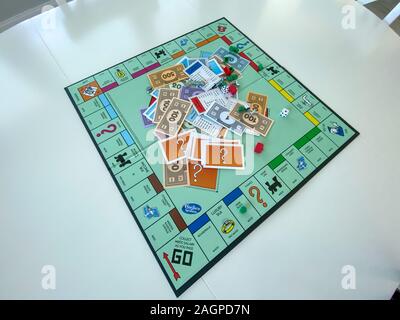 Orlando, FL/USA-12/20/19:  Pieces for the game Monopoly by Hasbro on a white background.  Concept business, banking, property, and game over. Stock Photo