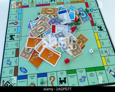 Orlando, FL/USA-12/20/19:  Pieces for the game Monopoly by Hasbro on a white background.  Concept business, banking, property, and game over. Stock Photo