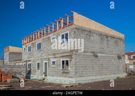 House under construction. Just after instalation of fibreboard on the roof. Wooden planks and pressed wooden OSB panels. Stock Photo
