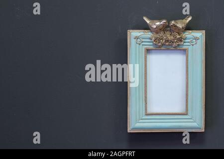 Empty mint golden vintage square frame in Victorian style on a gray wall, background or concept Stock Photo