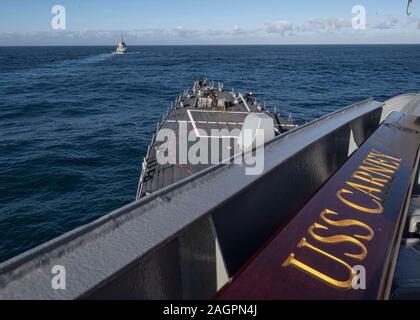 191217-N-TI693-1174    ATLANTIC OCEAN (Dec. 17, 2019) - The Arleigh Burke-class guided-missile destroyer USS Carney (DDG 64) sails in formation with the Alvaro de Bazan-class Frigate ESPS Alvaro de Bazan (F 101) during a routine passing exercise with the U.S. Navy’s destroyer squadron 60 and the Spanish Navy’s 31st surface squadron, Dec. 17, 2019. Carney, forward-deployed to Rota, Spain, is on its seventh patrol in the U.S. 6th Fleet area of operations in support of regional allies and partners as well as U.S. national security interests in Europe and Africa. (U.S. Navy photo by Mass Communica Stock Photo