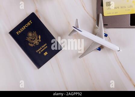 Booking tickets online on laptop and credit card preparing for vacation business trip with USA passport Stock Photo