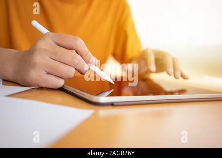 Business man , graphic designer or interior designer working with stylus pen using drawing digital tablet with home office.  Using smartphone tablet. Stock Photo