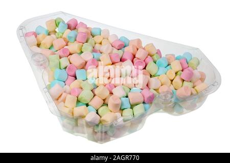 A bunch of small multi-colored marshmallows in a transparent plastic box. Isolated macro food Stock Photo