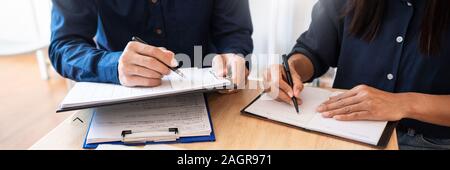 Young students classmates help friend catching up workbook and learning tutoring in a library, education and school concept. Stock Photo