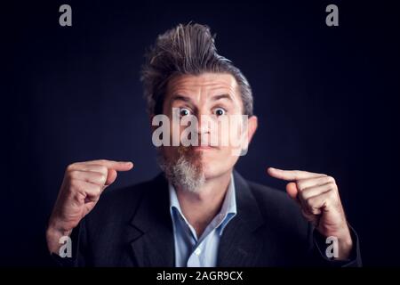 Half bearded funny man wearing suit in front of black background. People and skin care concept Stock Photo