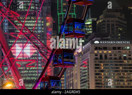 The famous Mandarin Oriental Hotel, HSBC bank and the observation Wheel, Central financial district, Hong Kong, China. Stock Photo