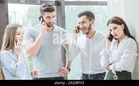 Four young employees Two men and two women employees communicate in a casual conversation Business conversation Stock Photo