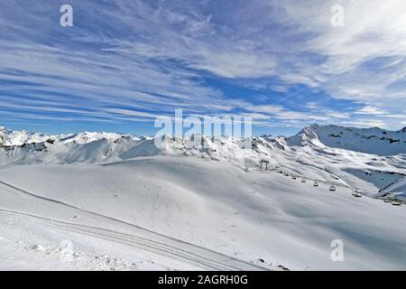 Snow covered French Alps and lift chairs on a sunny winter day. Glaciere de la Grande Motte of Tignes, France. Stock Photo