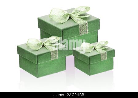 Three green gift boxes isolate on a white background, close-up, reflection. Stock Photo