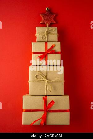 Creative concept holiday celebration photo of christmas toys balls decoration present box on red background.